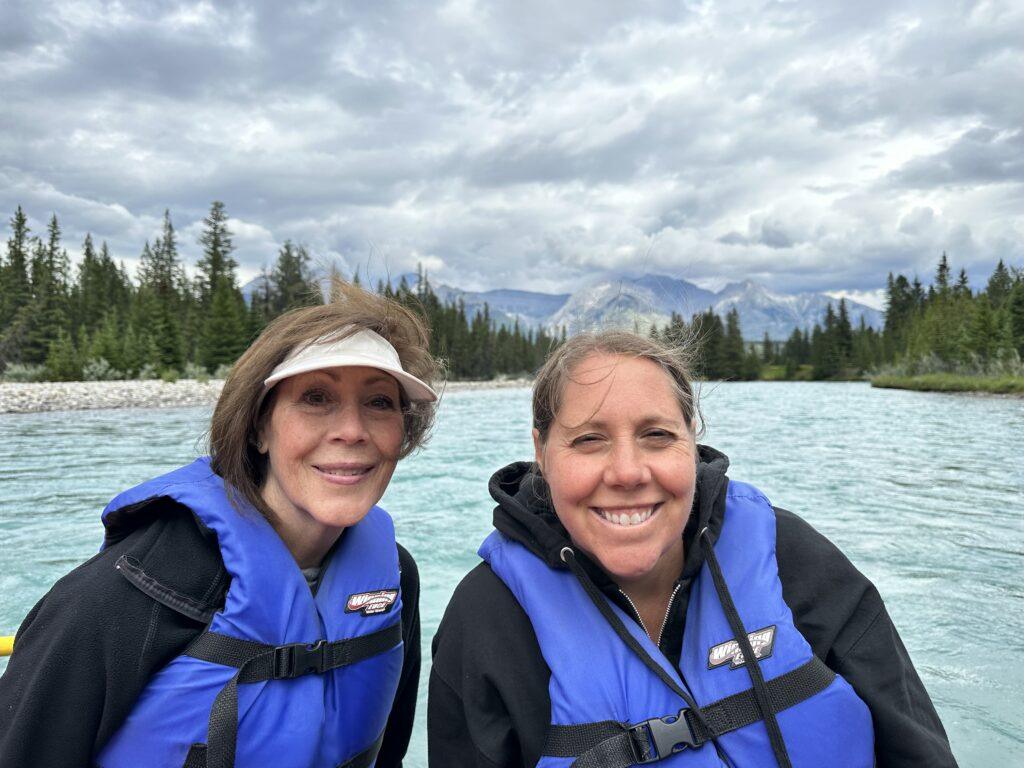 woman and daughter on river with lifejackets