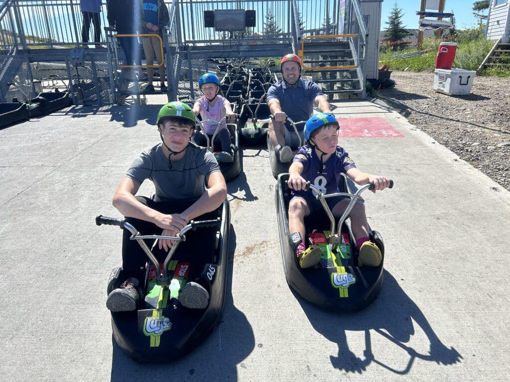 man with kids in go karts