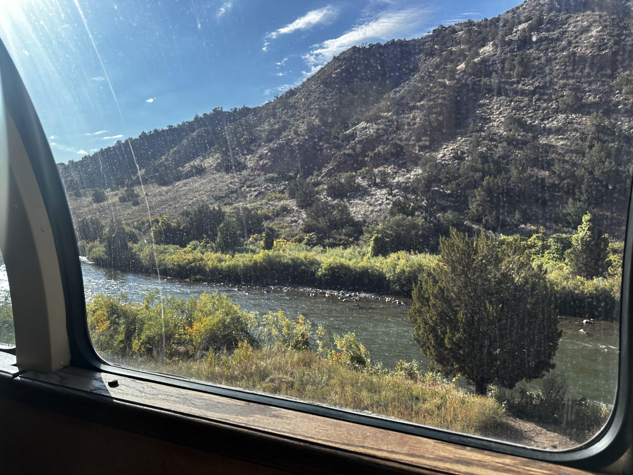 Arkansas River and rocky hillside seen through a Royal Gorge train window