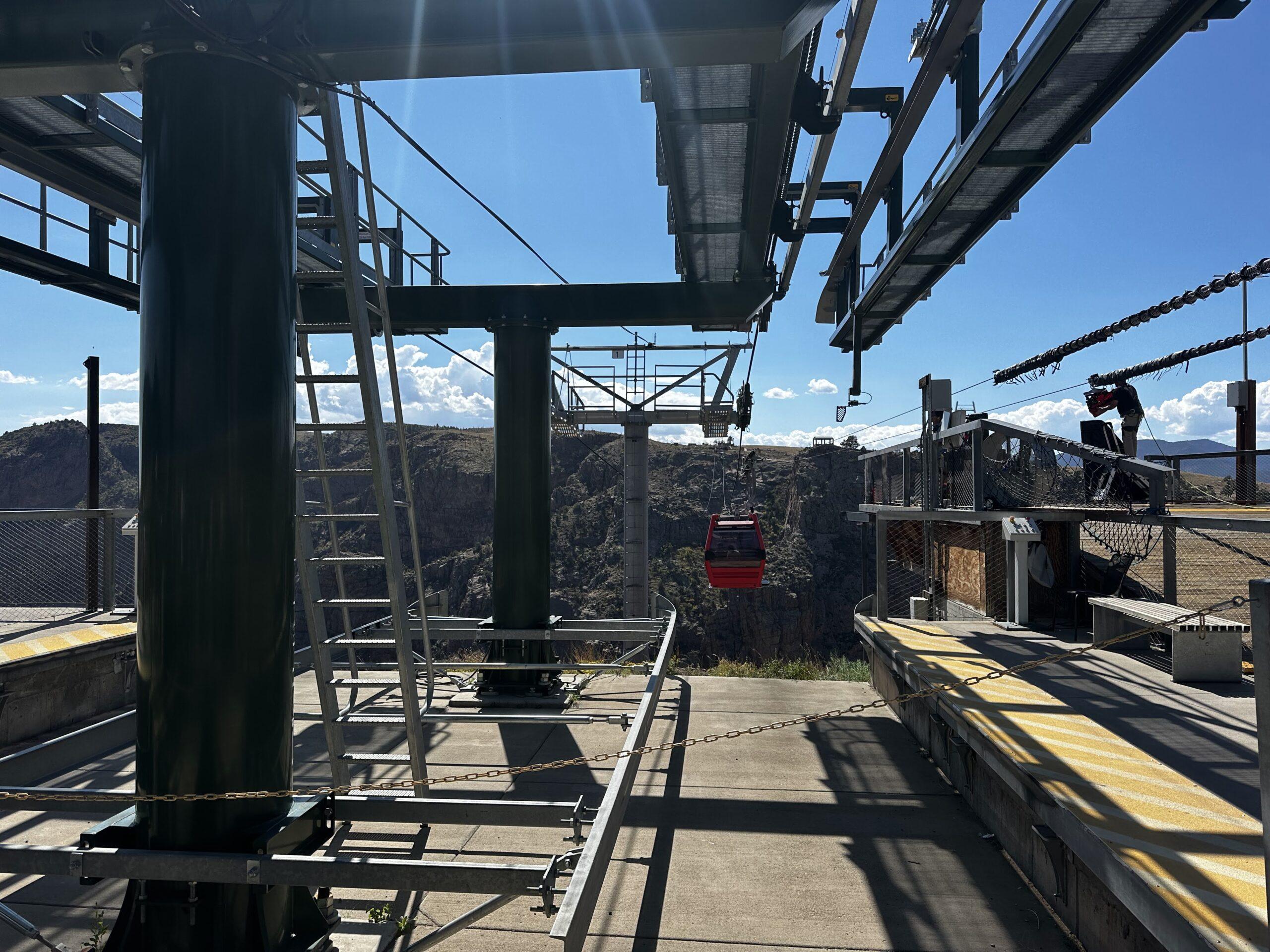 Red gondola approaching the boarding station above Royal Gorge near Cañon City