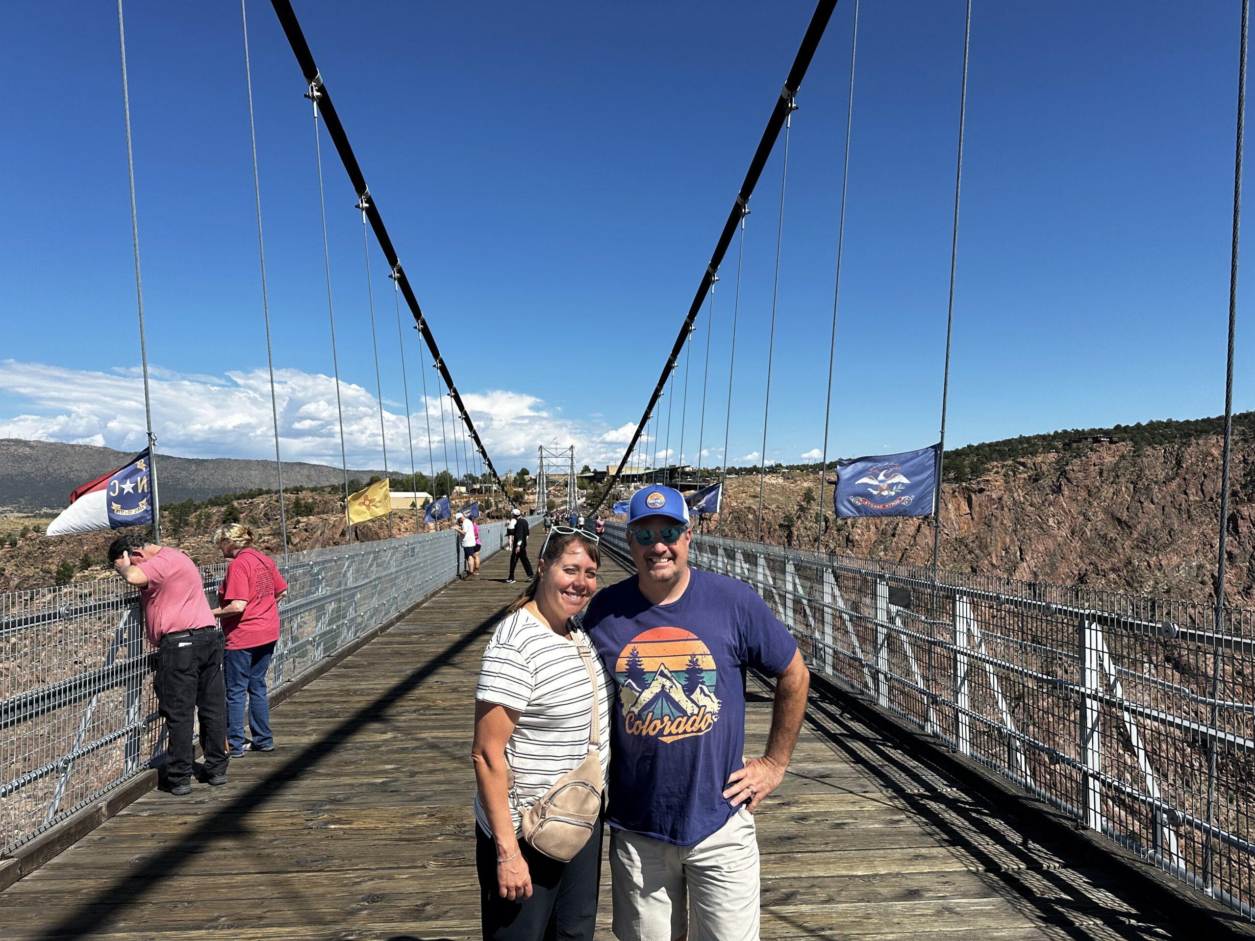 Cheryl and Matt standing on the Royal Gorge suspension bridge above the canyon