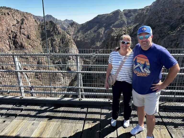 Cheryl and Matt standing on the Royal Gorge Bridge with the canyon behind them