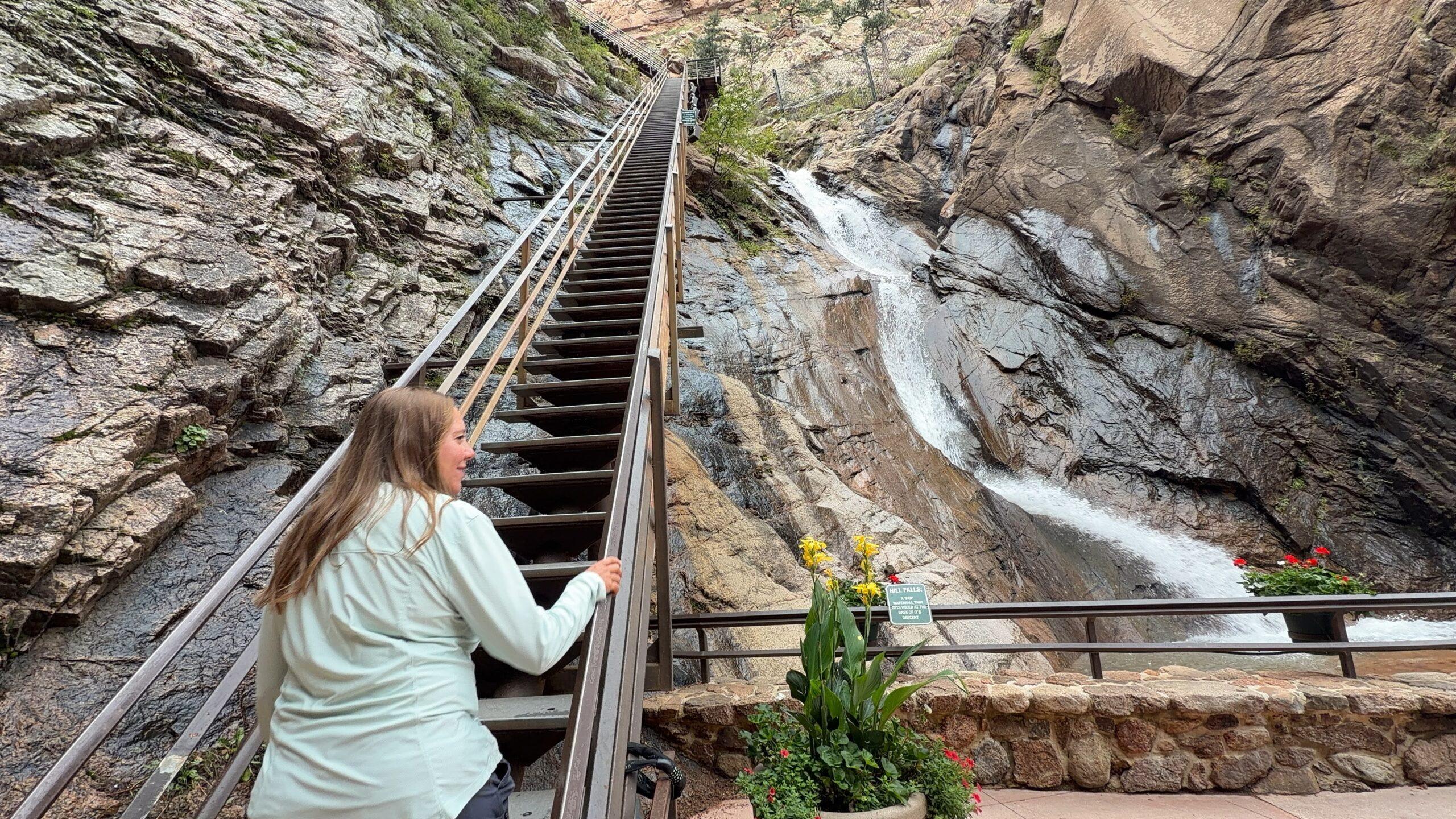 Cheryl beside the long staircase and cascading waterfalls at The Broadmoor Seven Falls