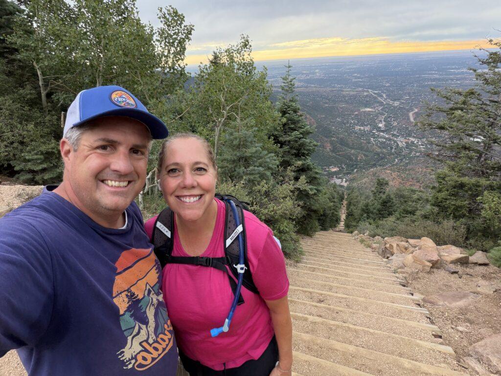 Matt and Cheryl at the top of the Manitou Incline with the steep staircase and valley behind them