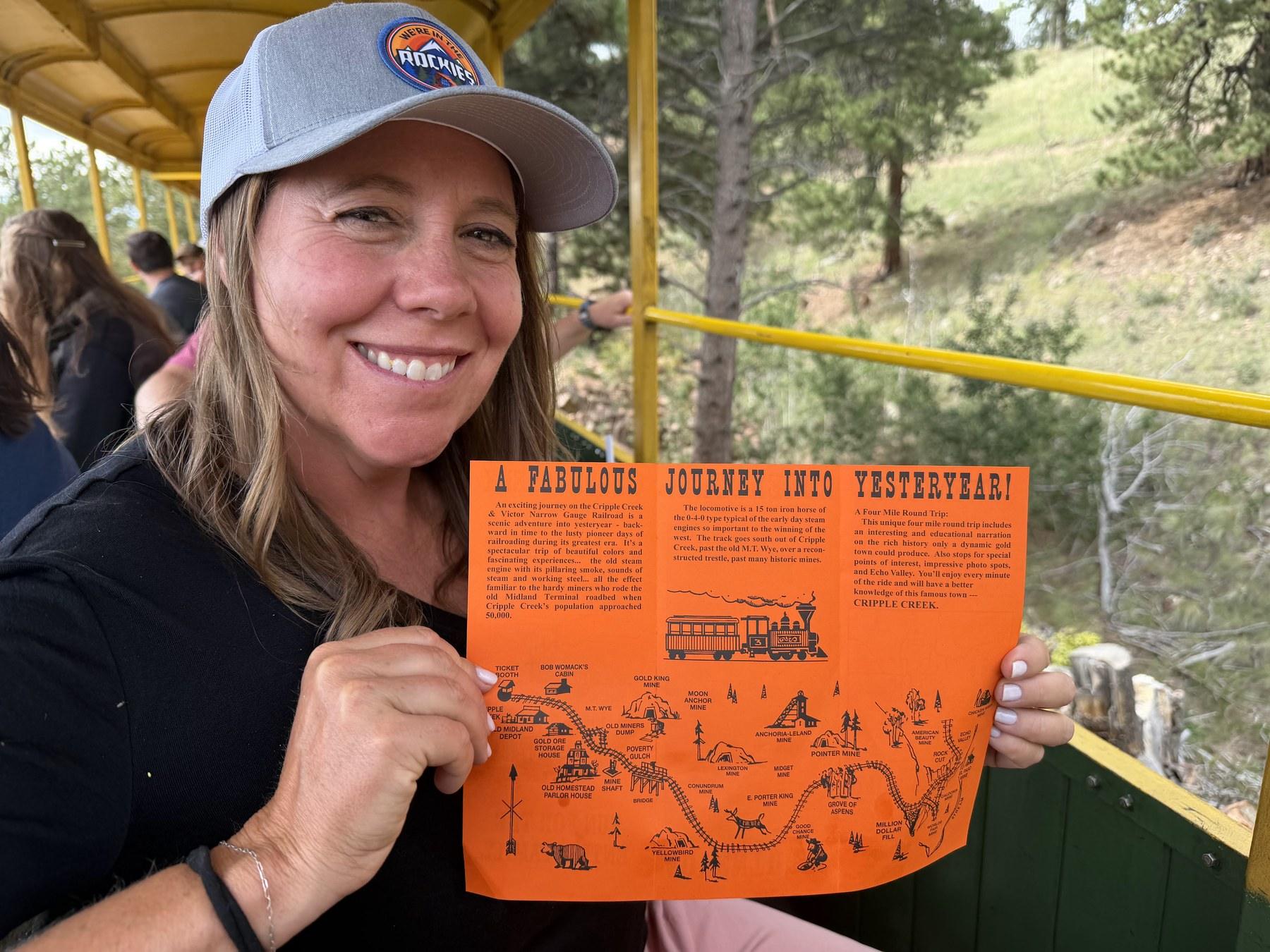 Cheryl holding the illustrated route map aboard the Cripple Creek train.