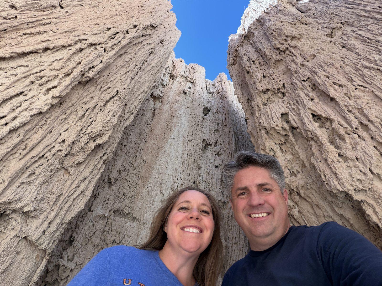Matt and Cheryl smile together inside a narrow clay passage at Cathedral Gorge.