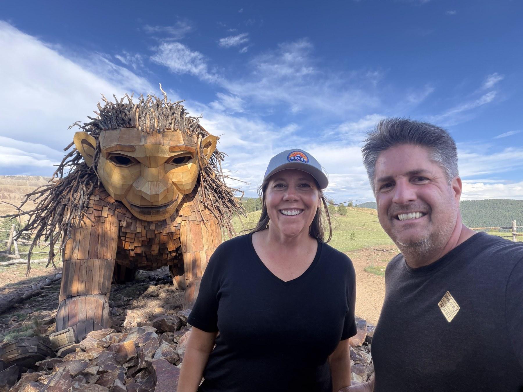 Matt and Cheryl standing beside Rita the Rock Planter troll near Victor, Colorado.